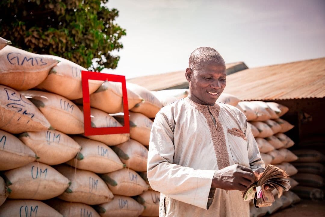 Man counting money made from his grains.jpg